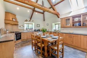 a kitchen with a wooden table and wooden cabinets at 2 Bed in Belsay oc-t29653 in Bolam