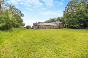 an old brick house with a large grass field at 2 Bed in Belsay oc-t29653 in Bolam