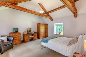 a bedroom with a bed and a desk and a television at 2 Bed in Belsay oc-t29653 in Bolam