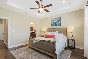 a bedroom with a bed with a ceiling fan at The Tipsy Twins - Entire Property in Canyon Lake