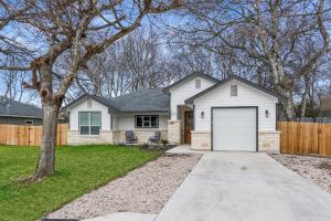 a house with a white garage and a fence at The Tipsy Twins - Entire Property in Canyon Lake