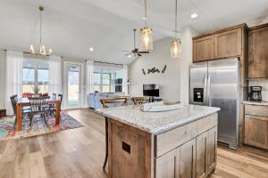 a kitchen and living room with a refrigerator and a table at The Tipsy Twins - Entire Property in Canyon Lake