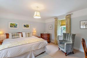 a bedroom with a bed and a chair and a window at 3 Bed in Askrigg oc-h29661 in Askrigg
