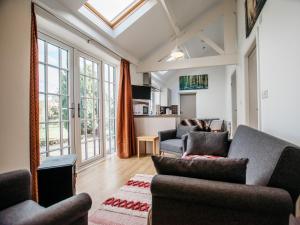 a living room with two couches and a large window at 2 Bed in Middlesbrough oc-75544 in Stokesley