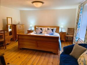 a bedroom with a large wooden bed with pillows at 3 Bed in Askrigg oc-w29833 in Marsett