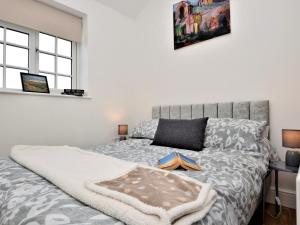 a bedroom with a bed with a blanket on it at 2 Bed in Middlesbrough oc-75544 in Stokesley