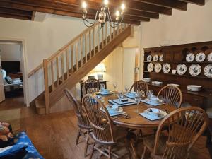a dining room with a table and chairs and a staircase at 3 Bed in Askrigg oc-w29833 in Marsett
