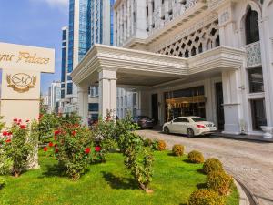 a white car parked in front of a building with flowers at Meyra Palace in Ankara