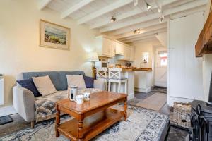 a living room with a couch and a table at 1 Bed in Askrigg oc-n28350 in Askrigg +16 photos