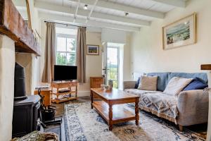 a living room with a couch and a tv at 1 Bed in Askrigg oc-n28350 in Askrigg
