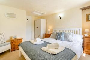 a bedroom with a bed with two towels on it at 1 Bed in Askrigg oc-n28350 in Askrigg