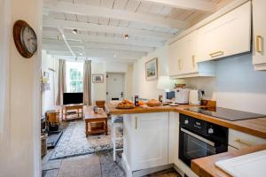 a kitchen with white cabinets and a counter top at 1 Bed in Askrigg oc-n28350 in Askrigg