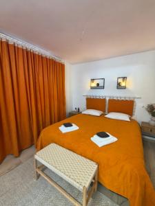 a bedroom with a bed with an orange blanket at Hotel Korona in Verbovatovka +168 photos