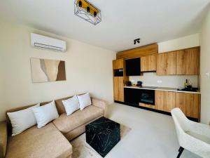 a living room with a couch and a table at MEDA Apartman in Sárvár