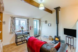 a living room with a couch and a fireplace at 1 Bed in Middleham oc-c30871 in Gammersgill