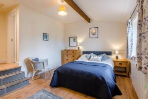 a bedroom with a bed and a desk and a chair at 1 Bed in Middleham oc-c30871 in Gammersgill