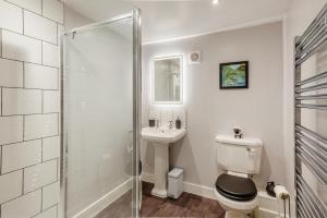 a bathroom with a toilet and a sink and a shower at 1 Bed in Middleham oc-c30871 in Gammersgill +18 photos