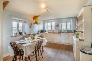 a kitchen with a table and chairs in a room at 2 Bed in Harmby oc-t30971 in Hornby