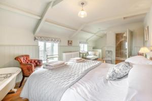 a bedroom with a large white bed and a chair at 2 Bed in Harmby oc-t30971 in Hornby