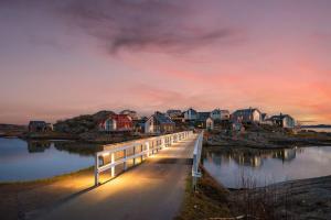 a bridge over a body of water with houses at Seaside House for 6 with Panoramic Ocean Views and Sauna near Gothenburg in Kärna