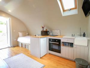 a kitchen with a sink and a bed in a room at 1 Bed in Rocester oc-a33054 in Rocester