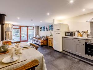 a kitchen with a table and a white refrigerator at 1 Bed in Frome oc-83834 in Holwell