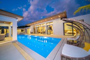 a swimming pool with a roller coaster in a house at Ming Resort Phuket in Mai Khao Beach