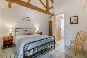 a bedroom with a bed and a chair at 3 Bed in Middleham oc-o32119 in Gammersgill