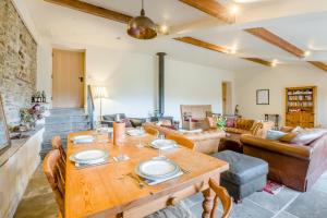 a large living room with a wooden table and chairs at 3 Bed in Middleham oc-o32119 in Gammersgill