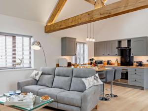 a living room with a couch and a kitchen at 1 Bed in Driffield oc-79277 in Wold Newton +20 photos