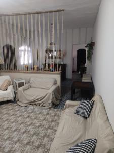 a living room with two beds and a table at Chácara braga in Itanhaém