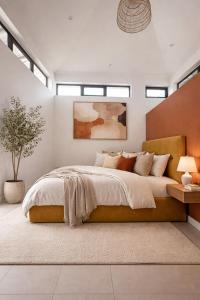 a bedroom with a large bed and windows at Fairview Holiday Villa in Rivière Noire