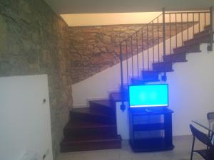 a tv sitting on a dresser next to a staircase at Corte Don Bosco 4 in Monfalcone