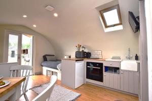 a kitchen and living room with a table and a dining room at 1 Bed in Rocester oc-e33057 in Rocester +7 photos