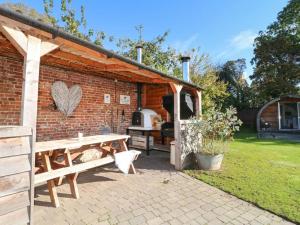 a brick shed with a picnic table and a grill at 1 Bed in Rocester oc-e33057 in Rocester