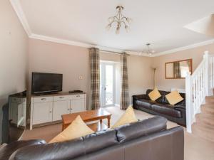 a living room with a couch and a tv at 3 Bed in Bamburgh oc-cn222 in Warenford