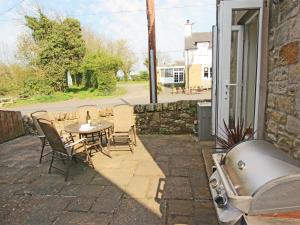 a patio with a table and chairs and a tub at 3 Bed in Bamburgh oc-cn222 in Warenford