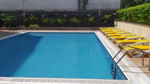 a large swimming pool with lounge chairs and a swimming pool at BLUESEA Copacabana in Lloret de Mar