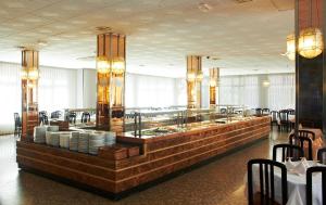 a restaurant with a buffet line with tables and chairs at BLUESEA Copacabana in Lloret de Mar