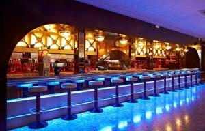 a bar with a row of stools in front of it at BLUESEA Copacabana in Lloret de Mar +7 photos