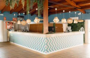 a bar in a restaurant with pendant lights at BLUESEA Marina Parc in Na Macaret +168 photos