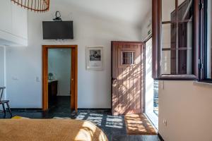 a bedroom with a bed and a television on the wall at Monte da Pechincha - Casa de Hóspedes & Spa in Estremoz