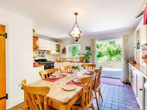 a kitchen and dining room with a wooden table and chairs at 2 Bed in Sway oc-nfl43 in Sway