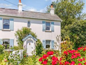 a white house with red flowers in front of it at 2 Bed in Sway oc-nfl43 in Sway +13 photos