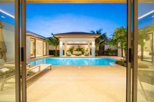 an image of a swimming pool in a house at Ming Resort Phuket in Mai Khao Beach