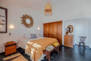 a bedroom with a bed and a mirror on the wall at Monte da Pechincha - Casa de Hóspedes & Spa in Estremoz +63 photos