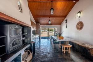 a kitchen with a long table and a dining room at Monte da Pechincha - Casa de Hóspedes & Spa in Estremoz