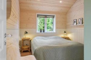 a bedroom with a bed in a room with a window at JB408-Brovst-Urbakken-2 in Brovst