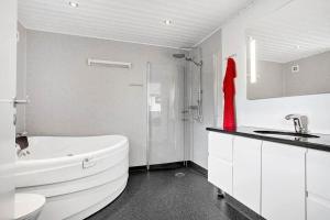 a white bathroom with a white tub and a sink at SJ323-Aabenraa-Kloften-14 in Loddenhøj +14 photos