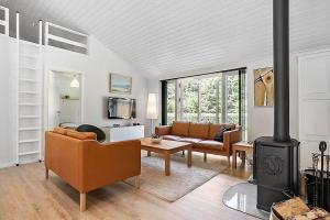 a living room with a couch and a fireplace at SJ323-Aabenraa-Kloften-14 in Loddenhøj